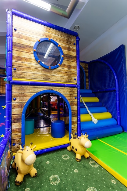 Close up of the blue and yellow big, inflatable castle labyrinth on the playground
