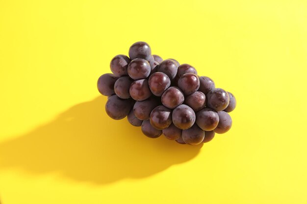 Photo close-up of blueberries against yellow background