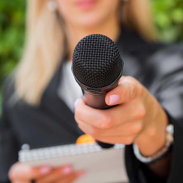 Close-up blurred journalist and microphone