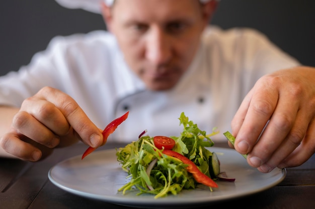 Close-up blurry chef preparing dish