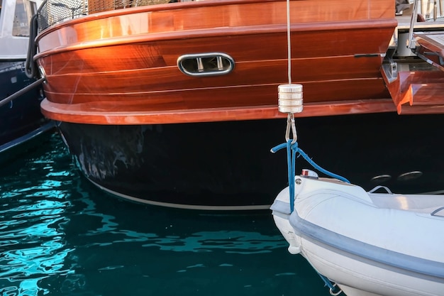 Close-up of a boat attached to a yacht in the port