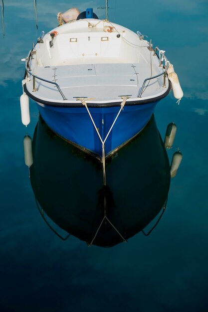 Close-up of boat moored on sea against sky