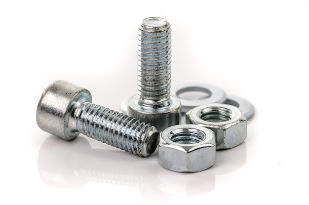 Photo close-up of bolts and nuts against white background