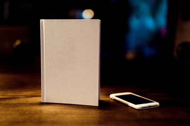 Close-up of book and mobile phone on table