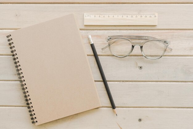 Close-up of book and pencil by eyeglasses