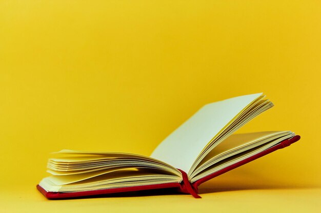 Close-up of book on table against yellow background