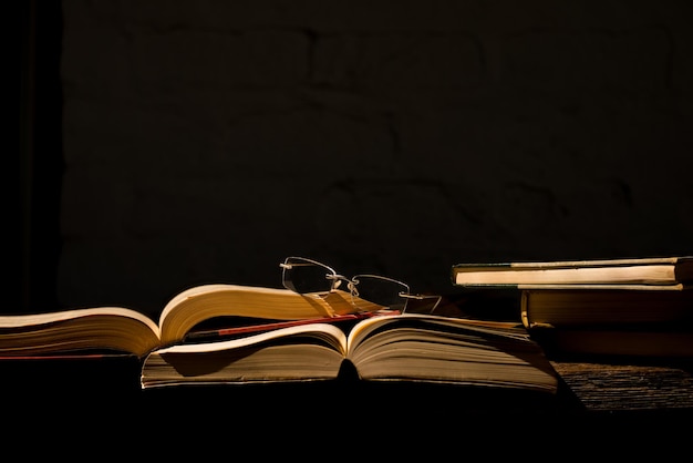 close-up of books on table against black background