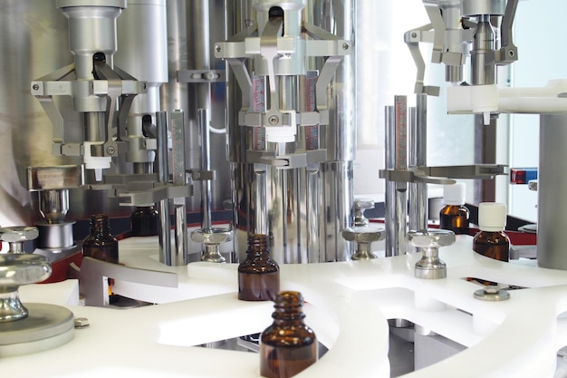 Close-up of bottles on machinery in chemical factory