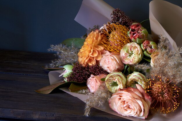 Photo close-up bouquet decorated in vintage style on a dark background, selective focus