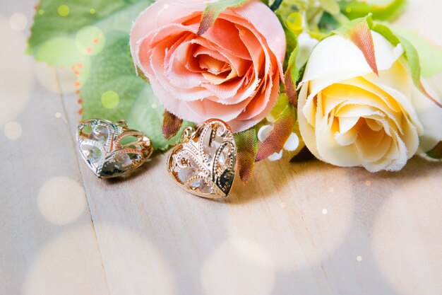 Close up bouquet Roses and heart shape on wooden background, pink vintage and valentine concept.