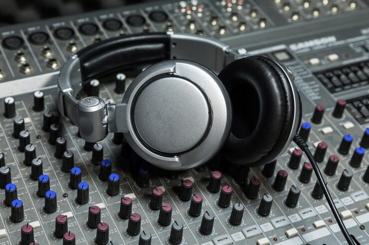 Close-up of boutique recording studio control desk, dj headphones for professional disc,  equipment for sound recording studio, mixer and DJ headphones