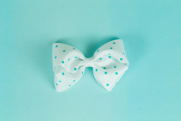 Close-up of bow tie against turquoise background