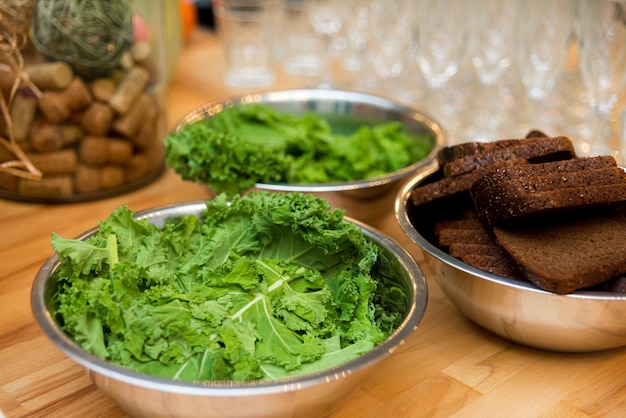 Close up of a bowl of kale and bread on a wooden table