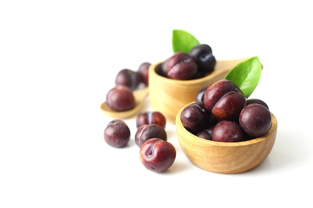 Close up bowl of plum and some on white background