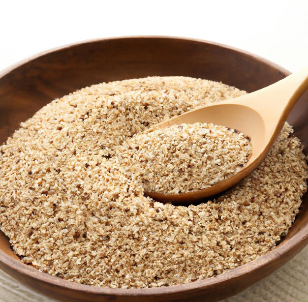 Close up of bowl and spoon with multiple grains of rice quinoa on white background