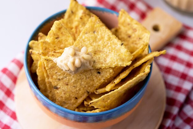 Close Up Bowl of Tortilla or Corn Chips on Wooden Tray Above Horizontal