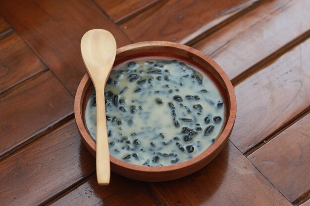 a close up of a bowl of traditional Indonesian drink called Dawet Ireng or black dawet Indonesian traditional food photo concept