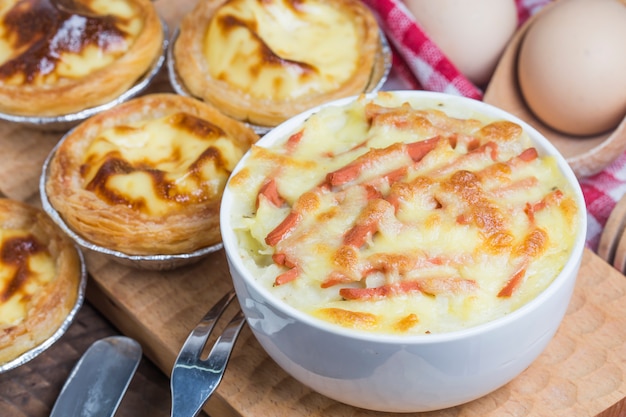 Close-up of bowl with vegetables and cheese melted