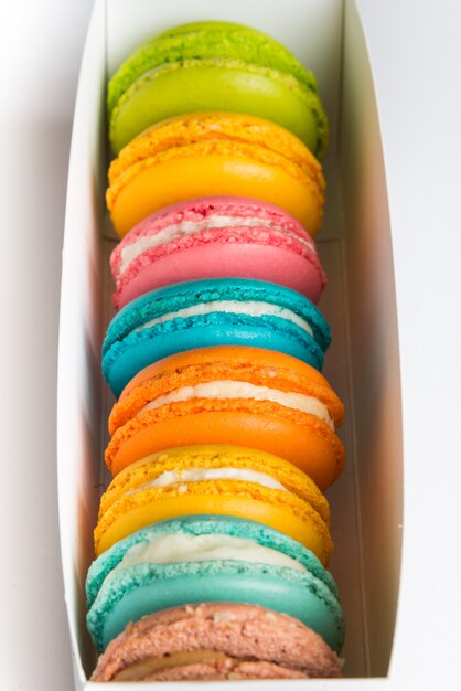 Close up of a box full of colorful macaroons.