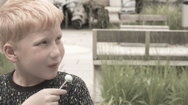 Close-up of boy holding lollipop