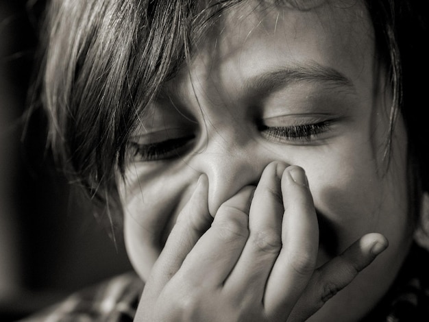 Close-up of a boy squeezing his nose