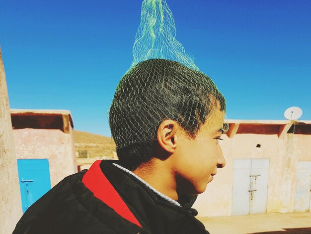 Close-up of boy wearing net