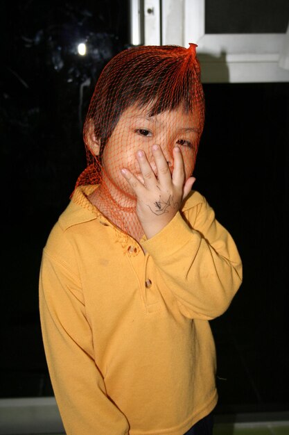 Close-up of boy wearing net