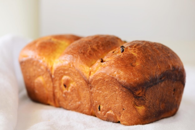 Close-up of bread on table against white background