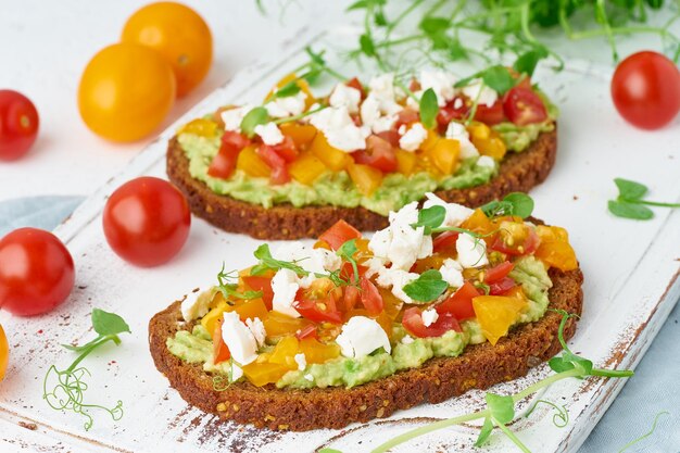 Close-up of breakfast with avocado toast served on cutting board