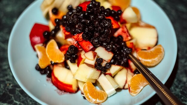 Close up breakfast with fresh fruits poured with sour cream and kefir