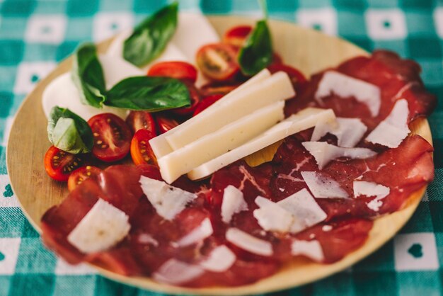 Bamboon 접시에 bresaola 음식을 닫습니다. 체중 감량 또는 다이어트를 위한 점심 및 자연 식품 개념 라이프 스타일