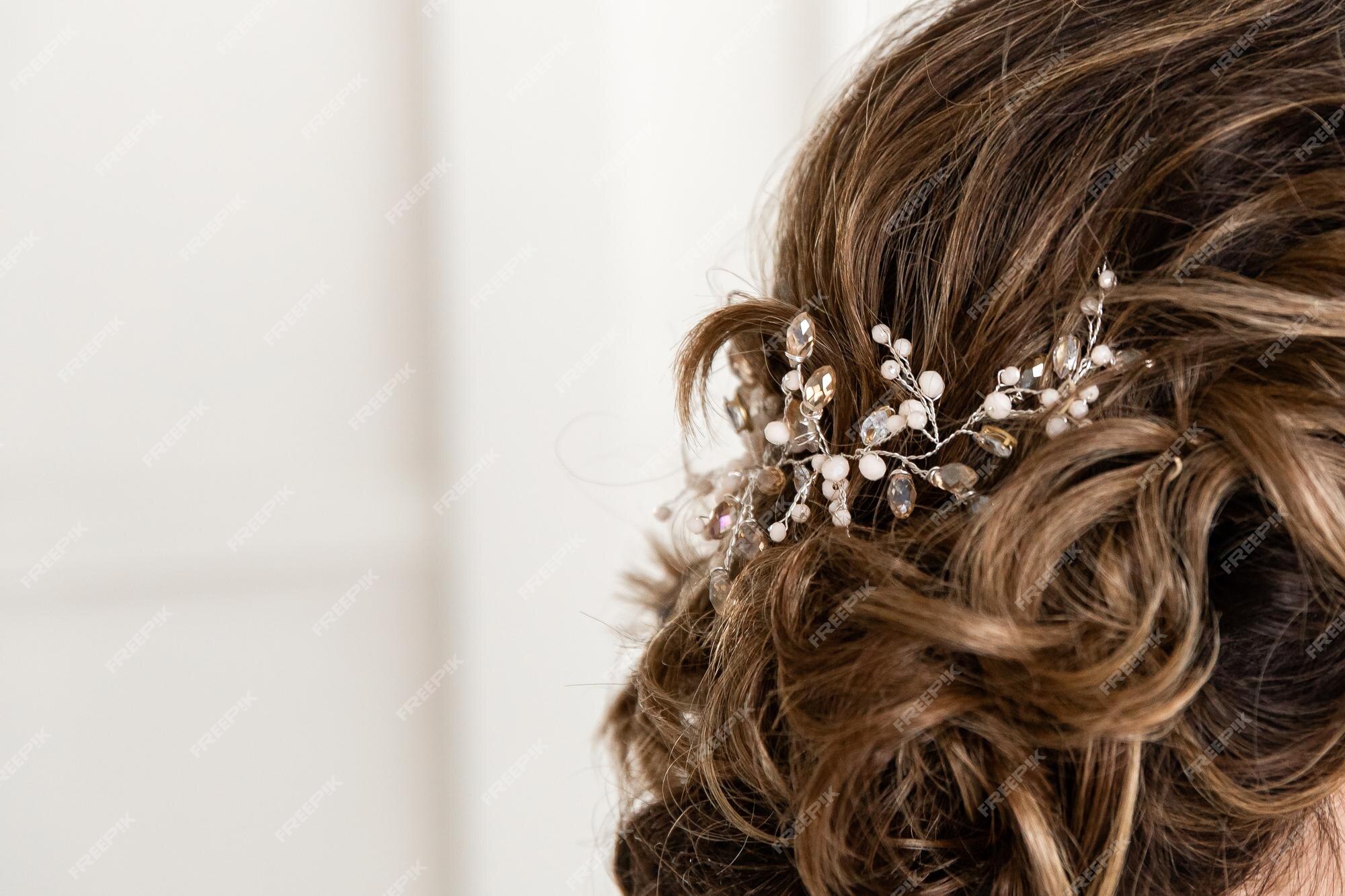 Premium Photo  Close-up of the bride's hairstyle. curls. jewelry with pearls  for hair. wedding ceremony. preparatio