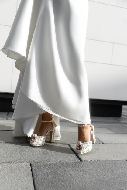 Close up of bride's legs in beautiful shoes. Preparing for the wedding.