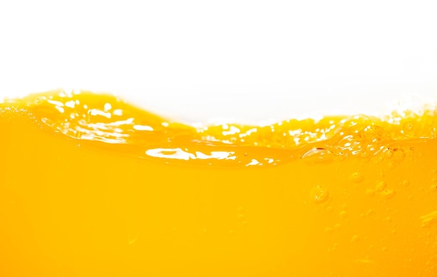 Фото Близкий яркий апельсиновый сок брызги текстуры для здоровья и природы волны красивые волны кривые и маленькие пузырьки гладкие для гарфического дизайна и фона