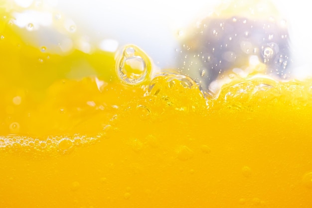 Photo close up bright orange juice splash texture for health and nature waves beautiful waves curve and little bubbles smooth for garphic design and background