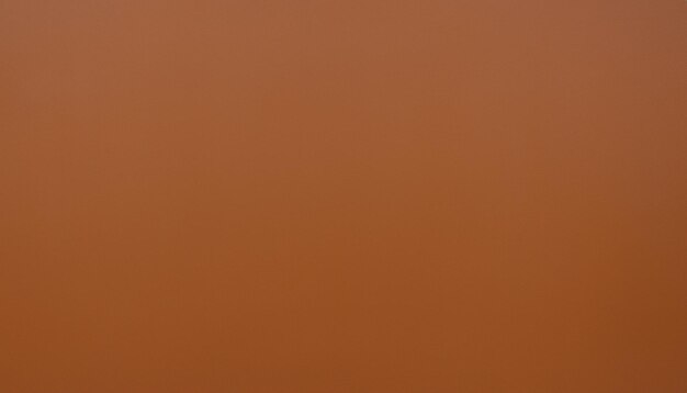 a close up of a brown background with orange clouds