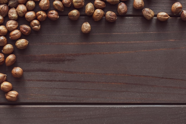 Close up brown hazel nut on wooden desk. Healthy organic vegetarian snack hazelnut. Place for text