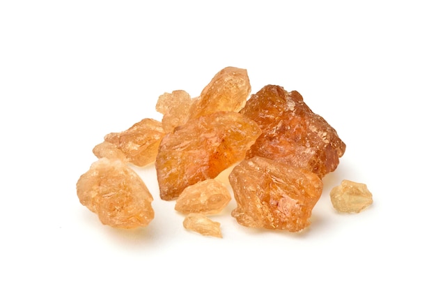 Close-up Brown natural  rock sugar made from sugar cane on white background.