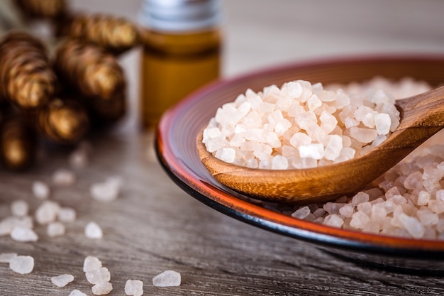 Close up brown organic Himalayan rock salt spa and cinnamon essential oil aroma 