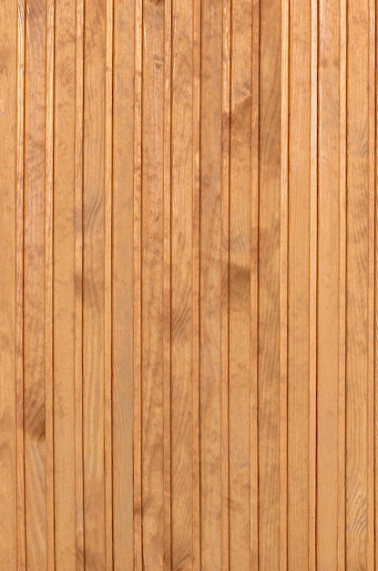 Close up of brown wooden fence panels. Many vertical wooden planks