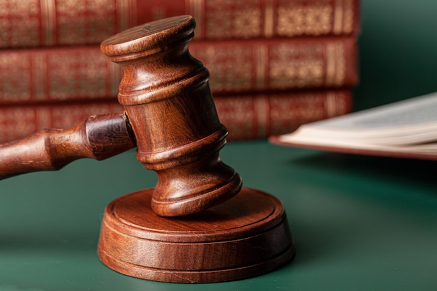 Close up of a brown wooden gavel and book