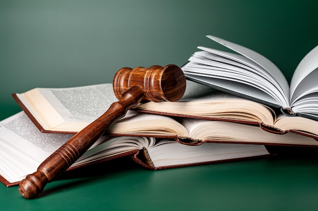 Close up of a brown wooden gavel and book