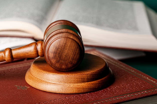 close up of a brown wooden gavel and book