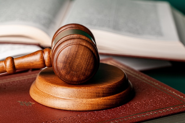 Close up of a brown wooden gavel and book