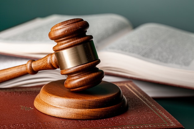 Close up of a brown wooden gavel and book