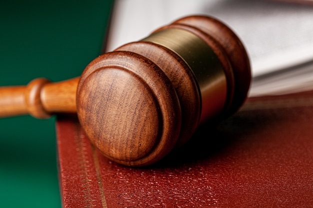 Close up of a brown wooden gavel and book