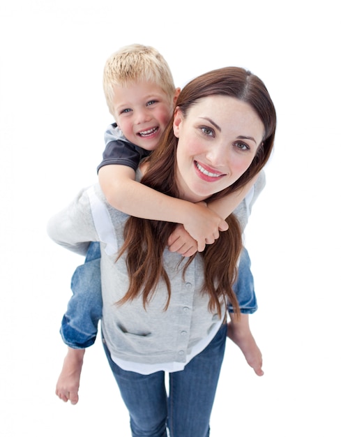 Photo close up of brunette mother giving her son piggyback ride