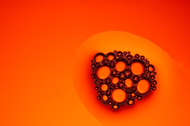 Close-up of bubble against orange background