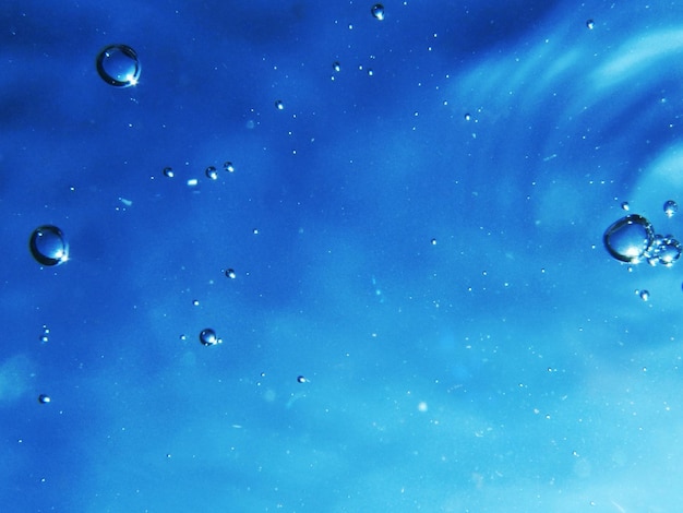 Close-up of bubbles against blue sky