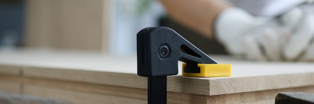 Close-up of building vise with wooden plank.